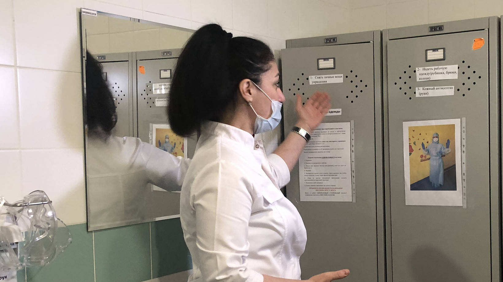 Лусине Оганян показывает шкафчики с СИЗами, где акушерская бригада готовится к принятию родов
